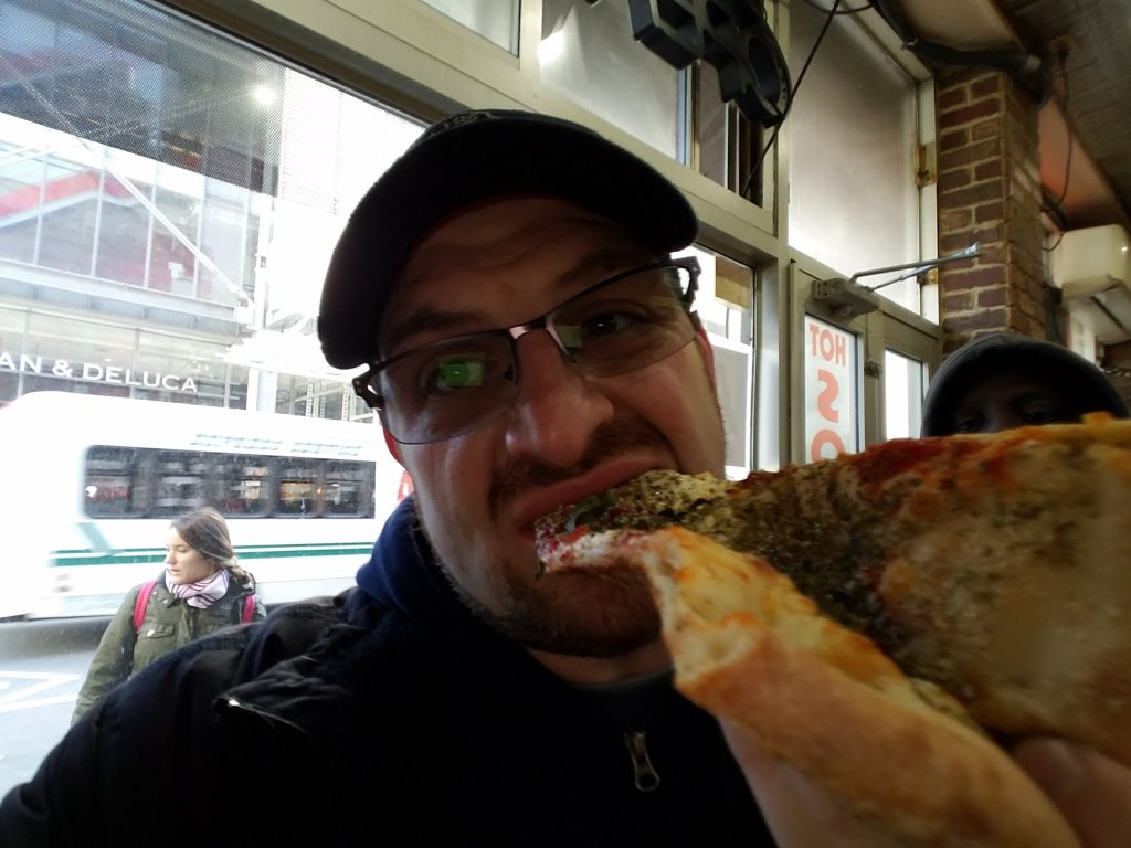 Nick biting into the most tasty pizza NY has to offer.